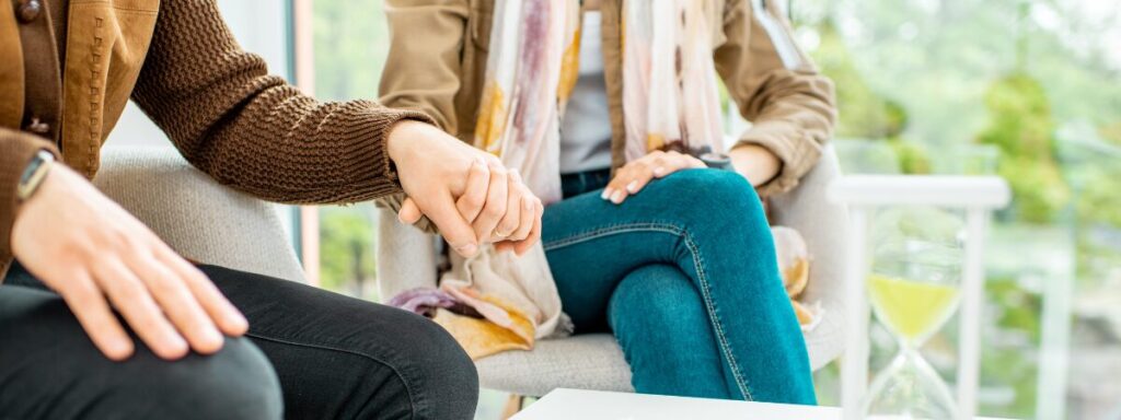 Couple holding hands in a therapy session, reflecting the supportive and collaborative nature of our couples therapy in Bergen County, NJ.
